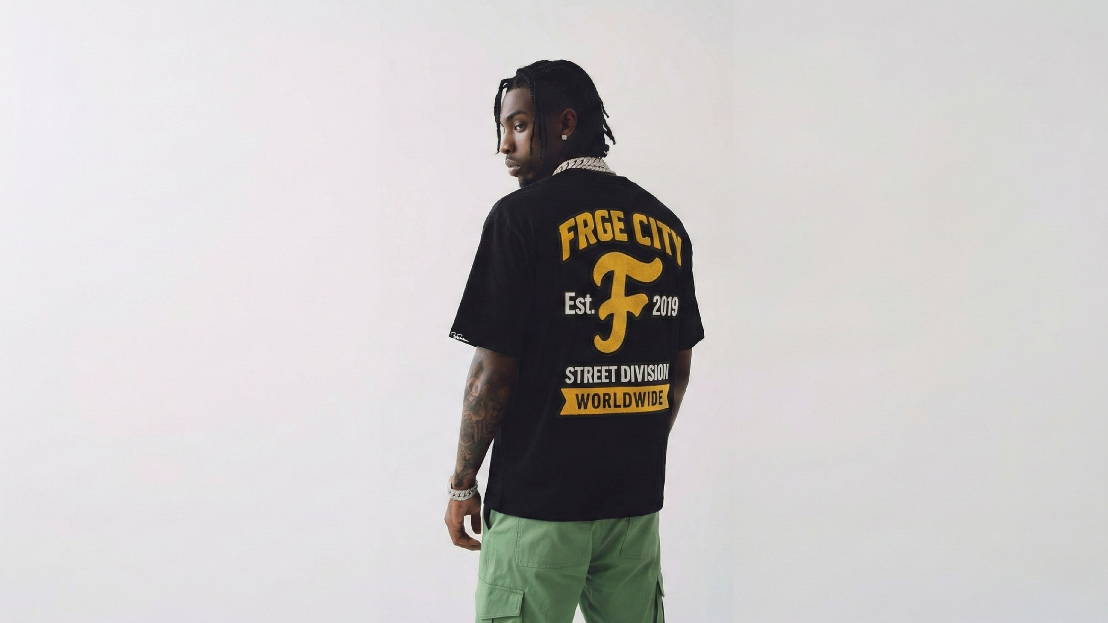 Person wearing a black t-shirt with yellow text on a white background